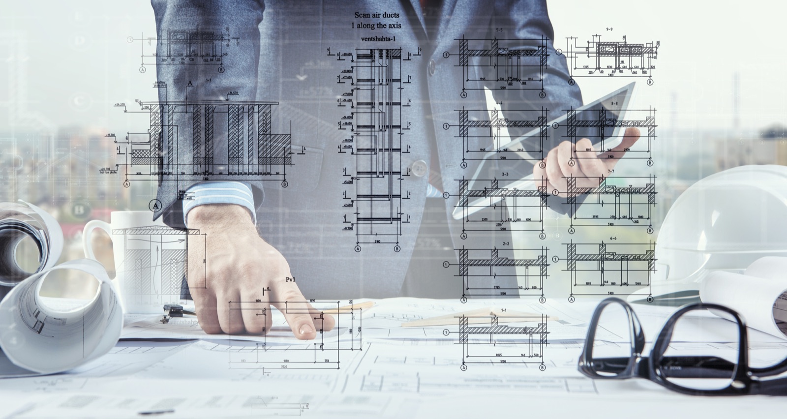 Engineer reviewing construction drawings on tablet
